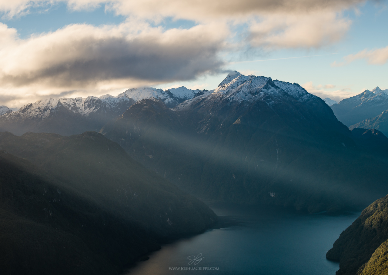 Crepuscular rays shining into the North Arm of Lake Manapouri, NZ.