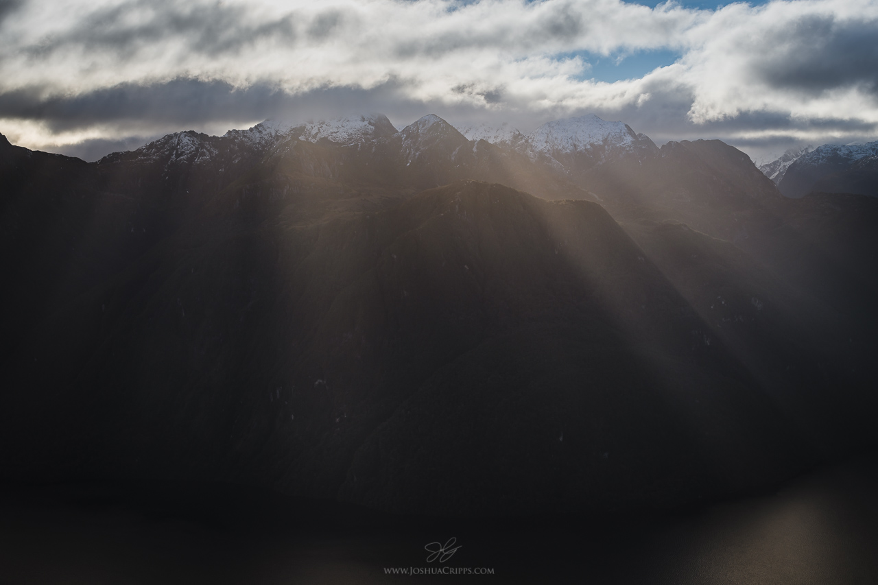 Crepuscular rays shining into Lake Manapouri, NZ.